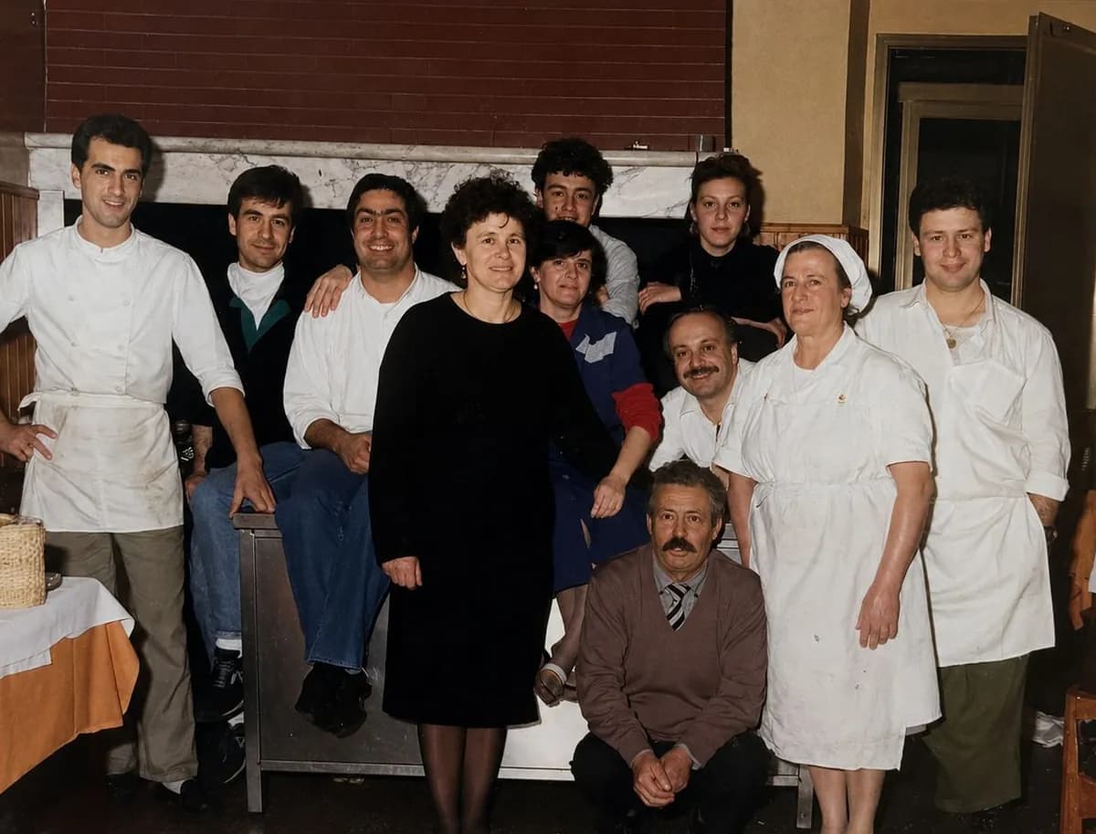 Foto storica della famiglia e della brigata di Paglia e Fieno in sala, con i cuochi in giacca bianca